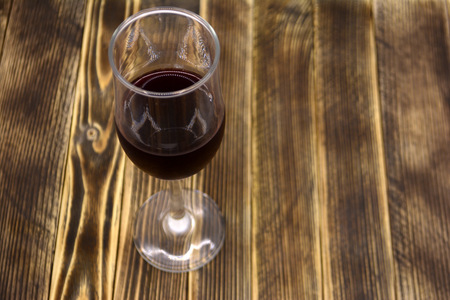 A glass of wine on a wooden backgroundの写真素材