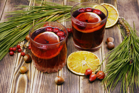 Hot winter or autumn cranberry drink on a wooden backgroundの写真素材