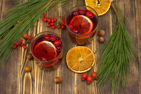 Hot winter or autumn cranberry drink on a wooden backgroundの写真素材