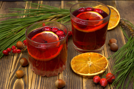 Hot winter or autumn cranberry drink on a wooden backgroundの写真素材