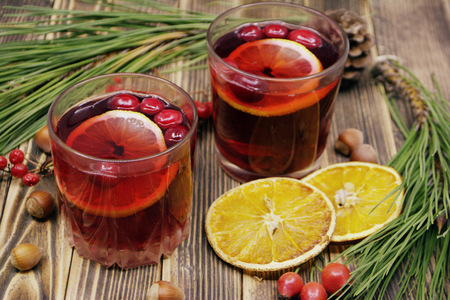Hot winter or autumn cranberry drink on a wooden backgroundの写真素材