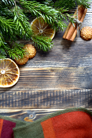 Christmas tree background cookies or Christmas tree cookies, cookies, cinnamon sticks and a scarf on a wooden backgroundの写真素材