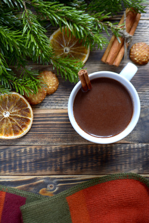 Hot chocolate or cocoa with cinnamon stick in a cup and fir branches. Winter hot drink for cold weather. New year and Christmas concept Top viewの写真素材
