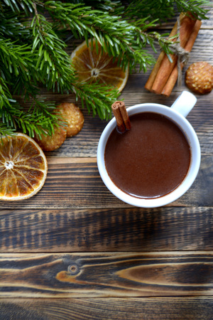 Hot chocolate or cocoa with cinnamon stick in a cup and fir branches. Winter hot drink for cold weather. New year and Christmas concept Top view Copy spaceの写真素材