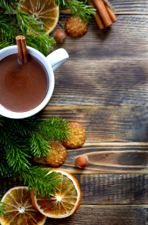 Hot chocolate or cocoa with cinnamon stick in a cup and fir branches. Winter hot drink for cold weather. New year and Christmas concept Copy spaceの写真素材