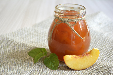 Homemade peach or apricot jam in a jarの写真素材