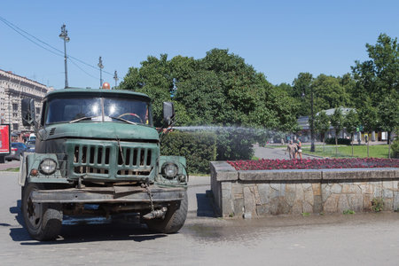 the man from the truck watering flowers
