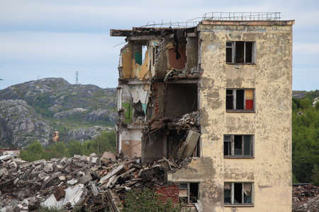 Russia, Gadzhievo - August 14, 2021: demolition of residential buildings with construction equipmentのeditorial素材