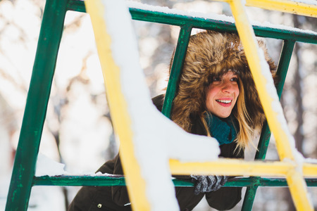 Young cute woman in the snow in the parkの写真素材