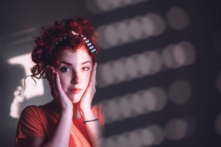 Young woman looking worried by the window
