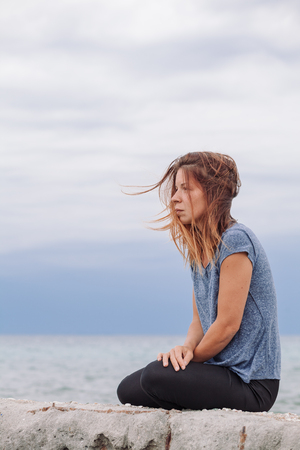Woman alone and depressed at seasideの写真素材