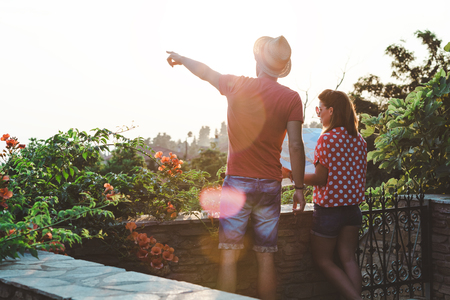 Young couple with the map at the balconyの写真素材