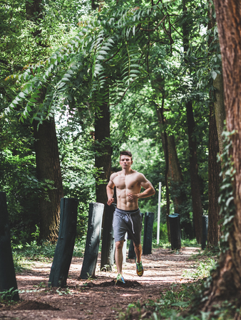 Young fit man running in the parkの写真素材