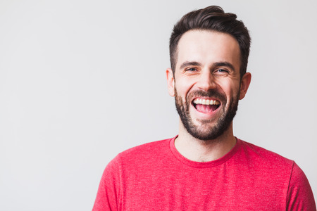 Portrait of a handsome young man laughingの写真素材