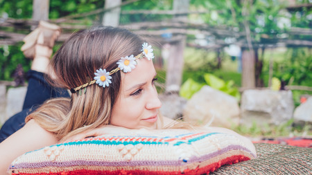 Beautiful hipster girl lying in the gardenの写真素材