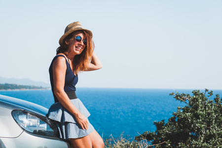 Young woman enjoying the view on a cliffの写真素材