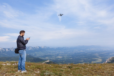 Young man flying drone over mountain