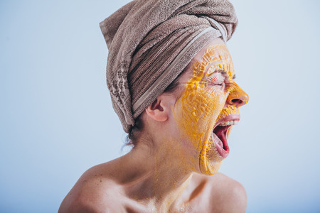 Young woman with an egg mask on her faceの写真素材