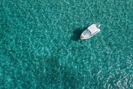Aerial view of a young woman enjoying on the boat on a sunny day
