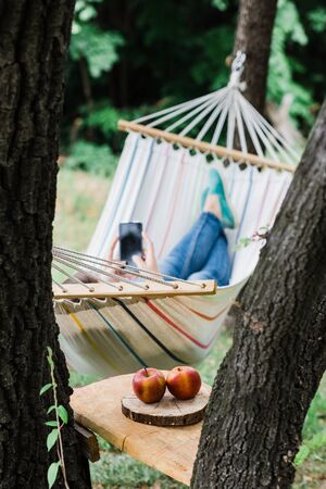 Young woman relaxing in the hammock in natureの写真素材