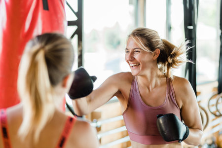 Young sporty woman in the gym boxing