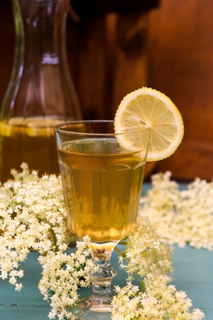 Elderflower juice with slice of lemon on rustic tableの写真素材