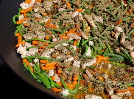 Cooking the potatoes provencal with chicken and vegetables in a big panの写真素材