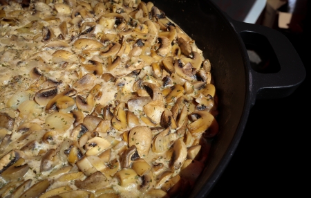 Fresh mushrooms in a creamy garlic sauce cooking in a big panの写真素材