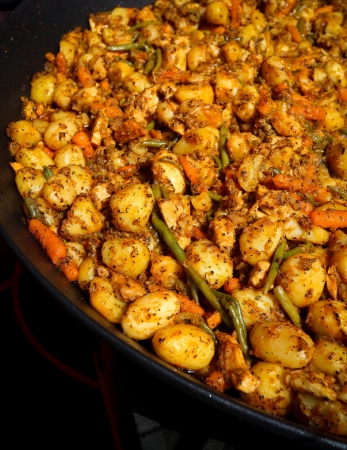 Potatoes provencal with chicken and vegetables in a big pan for big partyの写真素材