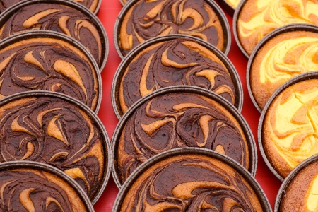 Chocolate tarts and Custard cream tarts on displayの写真素材