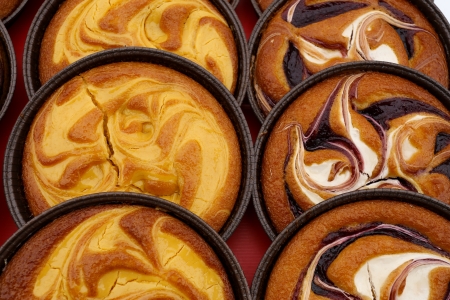Custard cream tarts and Raspberry tarts on displayの写真素材
