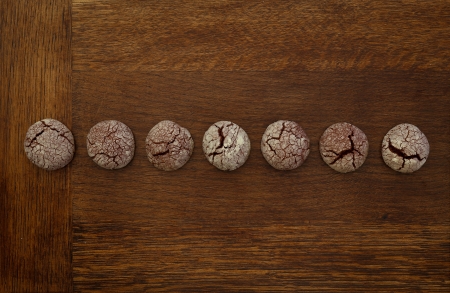 Chocolate cookies in line on wooden boardの写真素材