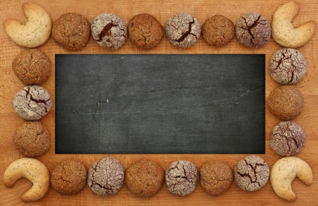 I Love You chalkboard, wooden frame with chocolate, ginger and hazelnut cookies, copy spaceの写真素材