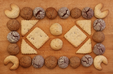 Chocolate, ginger and Hazelnut cookies frame on wooden board with stacking cookie ornamentの写真素材