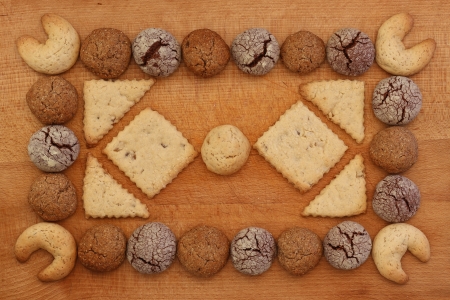 Chocolate, ginger and Hazelnut cookies frame on wooden board with stacking cookie ornamentの写真素材