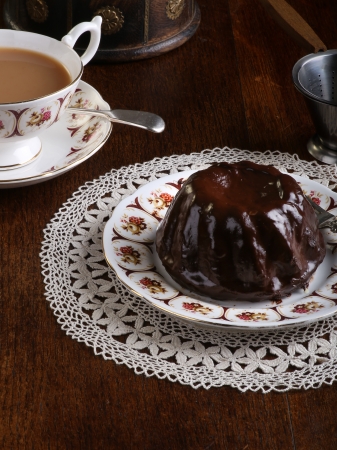 Mini Pound Cake - Chocolate hazelnut cake on old pictures tea cup and side plate on laceの写真素材