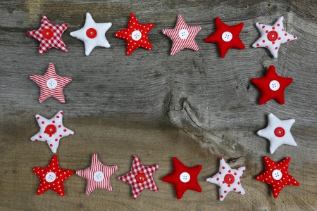 Christmas decoration red, white, gingham, stripes fabric stars with buttons  on rustic Elm wood background - retro style design, copy spaceの写真素材