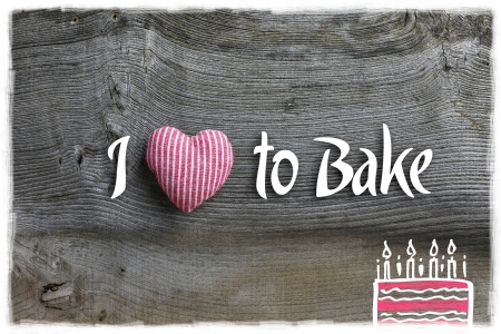 Love to bake message  handmade decoration red stripes fabric hearth over rustic Elm wood background - retro style designの写真素材
