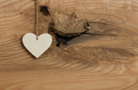 White Love Valentine s heart hanging on wooden texture backgroundの写真素材