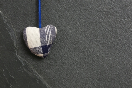 White Blue pattern Love Valentine s heart hanging on grey slate stone backgroundの写真素材