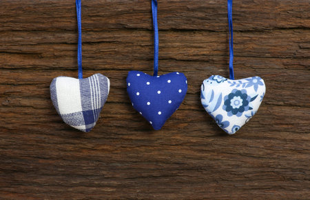 Blue pattern Gingham Love Valentine s hearts hanging on wooden texture backgroundの写真素材
