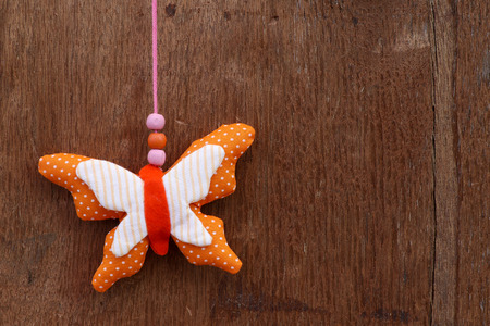 Interior decorations fabric stuffed butterfly toy on wooden backgroundの写真素材