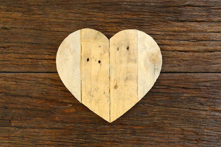 Love Valentines wooden heart from recycled old palette on rough driftwood background, copy spaceの写真素材