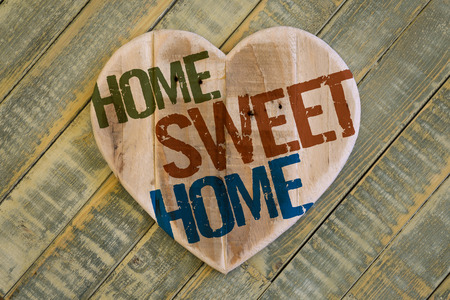 Home Sweet Home message wooden heart from recycled old palette on light green painted background, copy spaceの写真素材