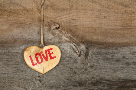 Love Valentines message wooden heart sign from recycled old palette on rough grey wood background, copy spaceの写真素材
