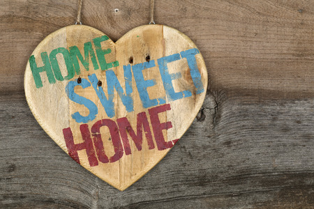 Home Sweet Home message wooden heart sign on grey backgroundの写真素材