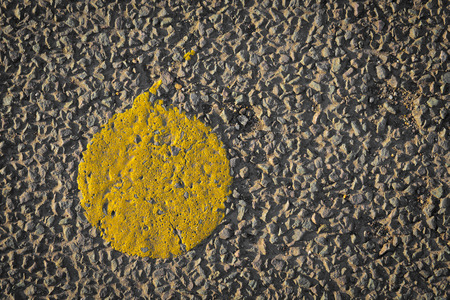 Asphalt with yellow paint dot road close up and copy spaceの写真素材
