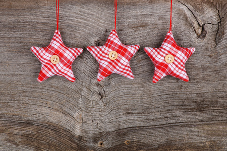 Red fabric star Merry Christmas handmade decoration over rustic Elm wood background - retro style design, copy spaceの写真素材