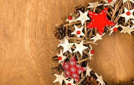 Christmas handmade wreath decoration Shabby Chic white wooden stars with red gingham fabric pattern over wooden background - retro style design, copy spaceの写真素材