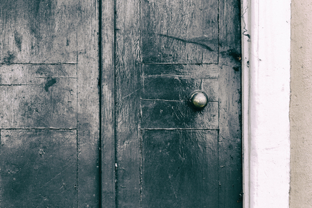 Weathered painted green wooden door grunge textures and backgroundsの写真素材